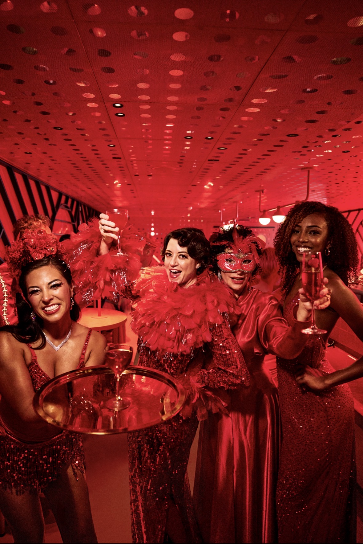 Guests in costumes and masks at a Virgin Voyages Halloween cruise party